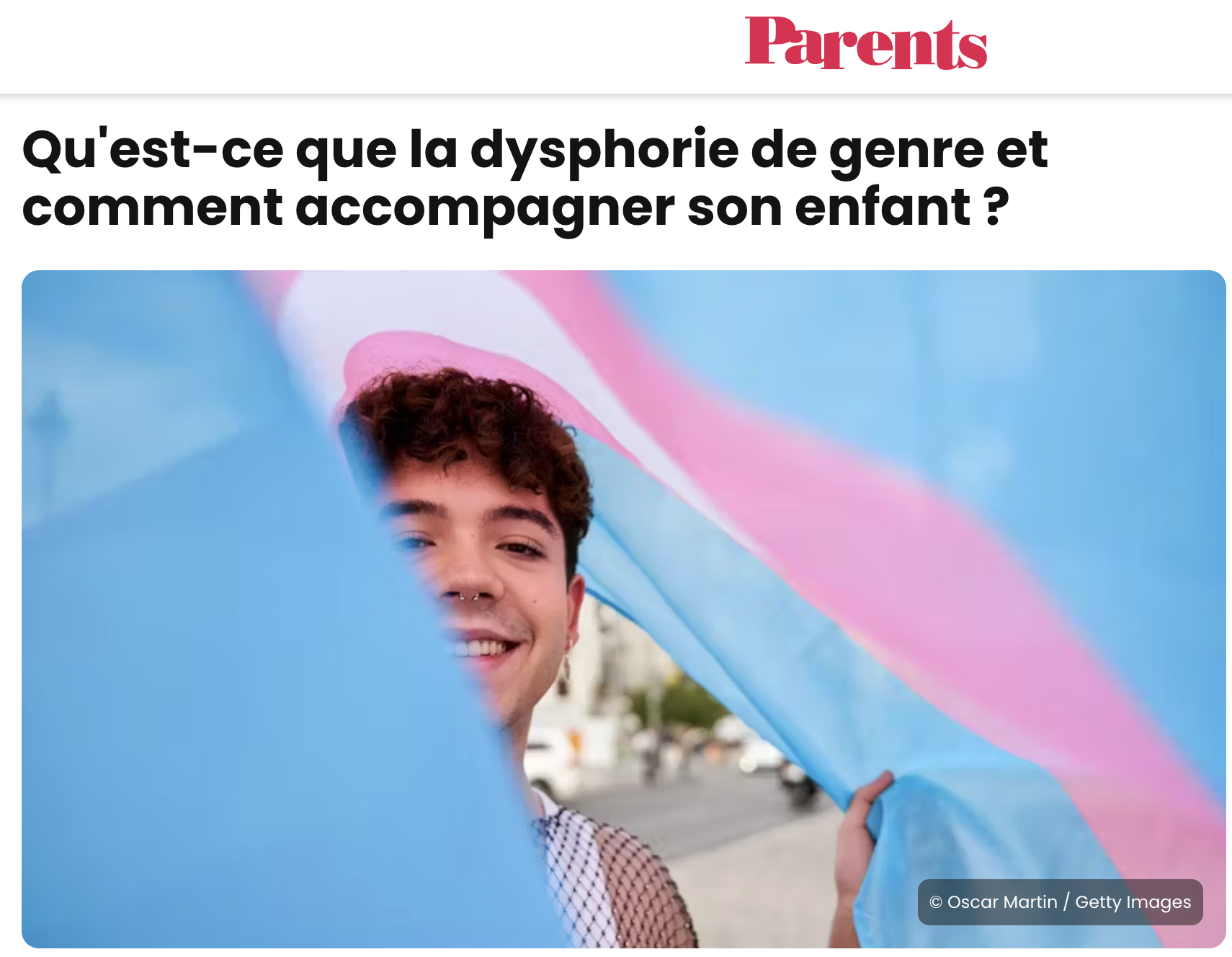 A teenage with a transgender flag